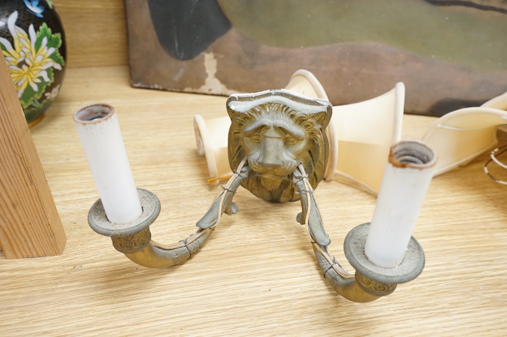 A pair of ‘lion mask’ gilt metal two branch wall sconces and four silk shades, 22cm wide
